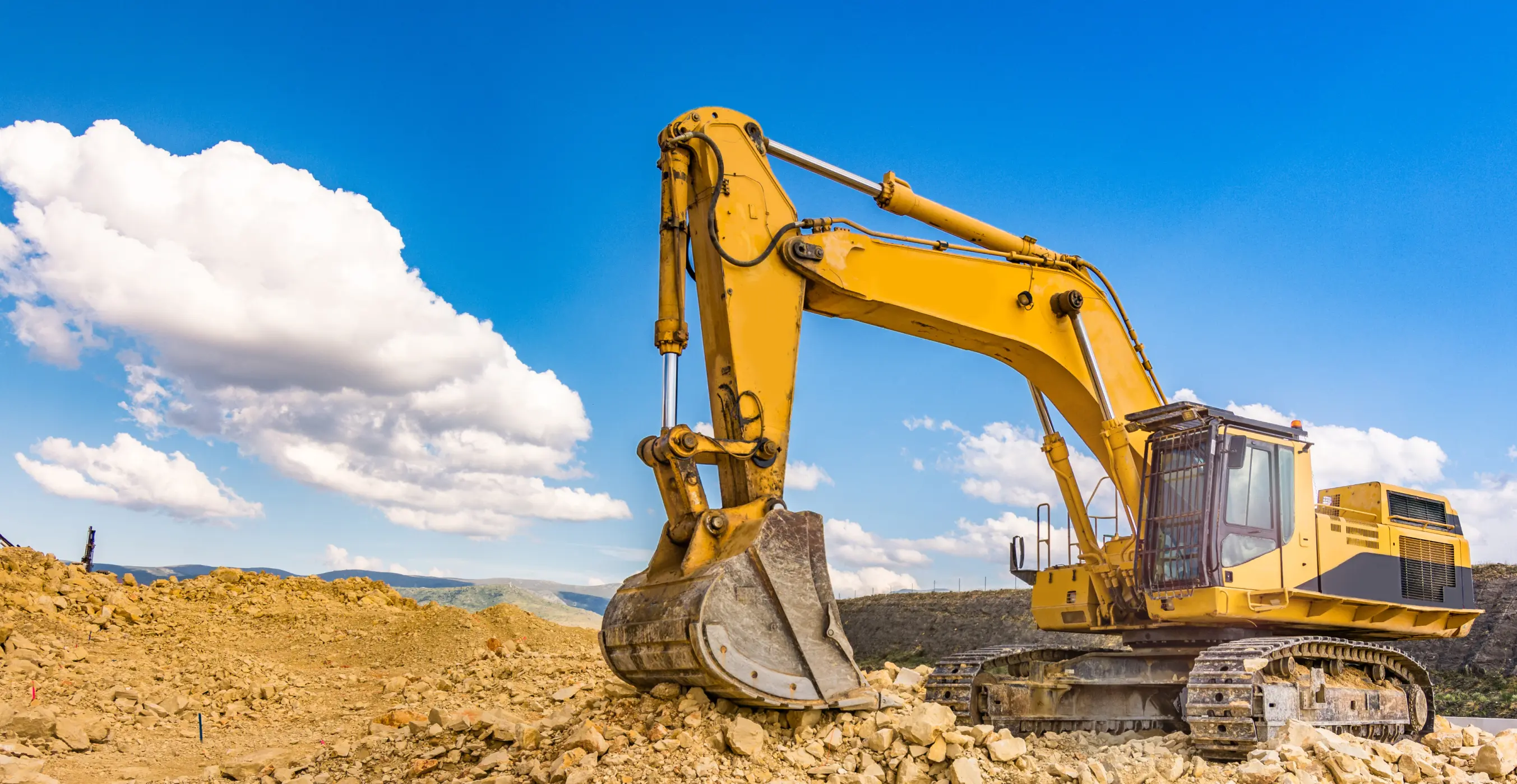 Yellow excavator at construction site