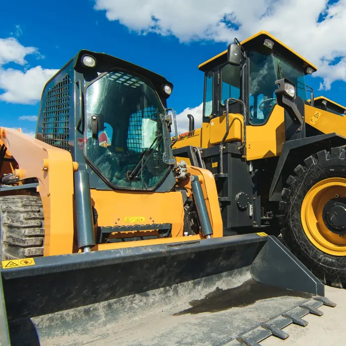 Construction vehicles under blue sky